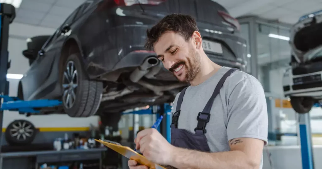A person writing on a clipboard with cars on the background