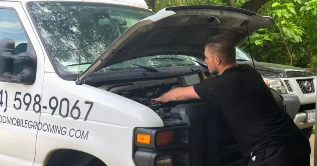 A person looking at the engine of a car