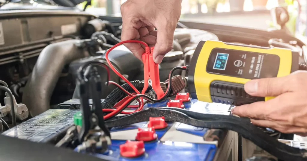 A hand holding a red and black cable
