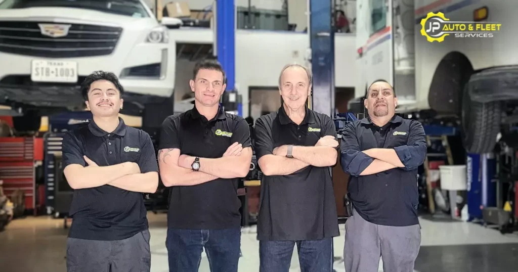 JP Auto auto technician standing in a line with their arms crossed