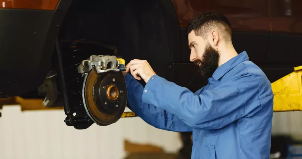 a mechanic fixing the brake pads
